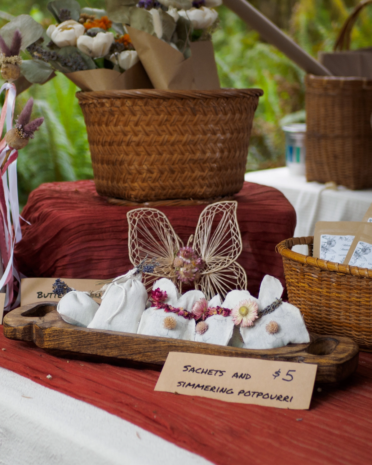 Linen sachets and simmering potpourri on a wooden tray